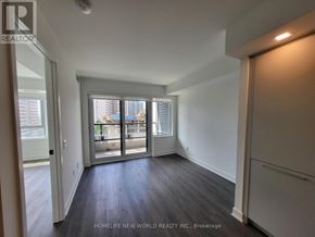 Toronto (North St. James Town) condo for rent - A room with a sliding glass door leading to a balcony.
