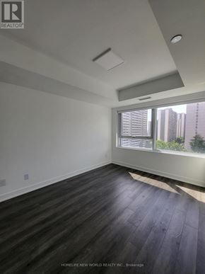 Toronto (North St. James Town) condo for rent - A room with a window and a wooden floor.