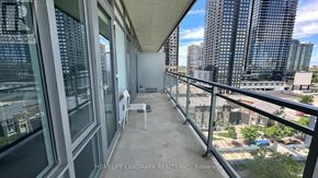 Mississauga (City Centre) condo for rent - A balcony with a table and chairs overlooking a cityscape.
