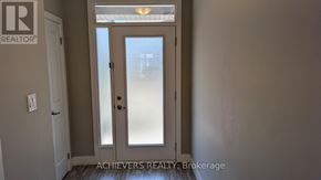 London North (North A) townhouse for rent - A door with a glass panel and a handle is in the center of the image.