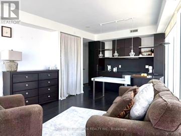 Toronto (Church-Yonge Corridor) condo for rent - A living room with a brown couch and a white table.