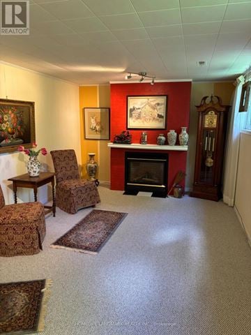 Barrie (Grove East) apartment for rent - A living room with a fireplace and a painting on the wall.