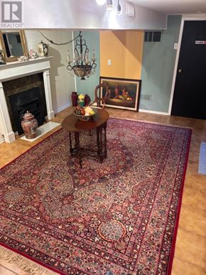 Barrie (Grove East) apartment for rent - A large oriental rug covers the floor of a room with a fireplace and a chandelier.