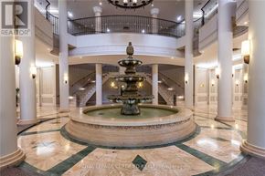 Mississauga (Hurontario) condo for rent - A large, ornate fountain is the centerpiece of a grand foyer with marble floors and white columns.
