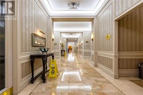 Mississauga (Hurontario) condo for rent - A long hallway with a yellow caution sign on the floor.