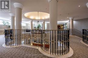 Mississauga (Hurontario) condo for rent - A large, elegant room with a spiral staircase and a chandelier.