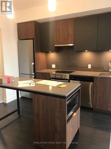 Toronto (Kensington-Chinatown) condo for rent - A modern kitchen with dark wood cabinets and stainless steel appliances.