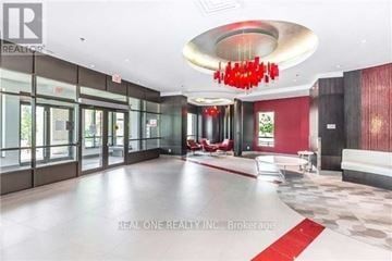 Markham (Berczy) condo for rent - A large, open space with a red chandelier and a red carpet.