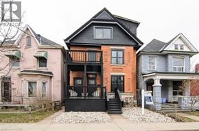 Hamilton apartment for rent - A house with a black front door and steps.