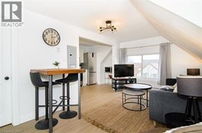 Hamilton apartment for rent - A living room with a bar stool and a clock on the wall.