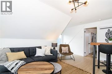 Hamilton apartment for rent - A living room with a grey couch and a wooden coffee table.