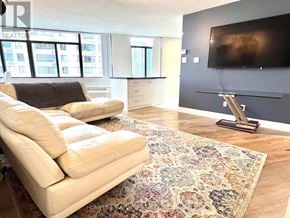 Toronto (Waterfront Communities) condo for rent - A living room with a rug, a couch, and a television.