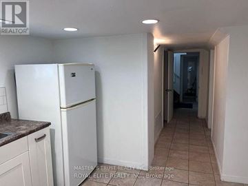 Toronto (Willowdale East) apartment for rent - A white refrigerator in a kitchen with a countertop and cabinets.
