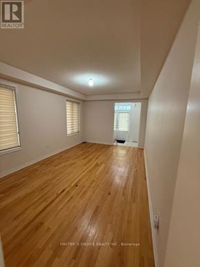 Brampton (Northwest Brampton) apartment for rent - A room with wooden flooring and a window with blinds.