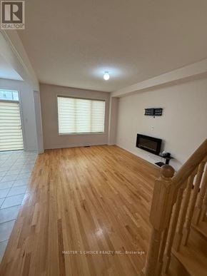 Brampton (Northwest Brampton) apartment for rent - A room with wooden floors and a fireplace.
