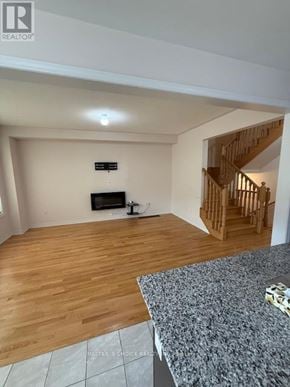 Brampton (Northwest Brampton) apartment for rent - A living room with a wooden floor and a staircase.