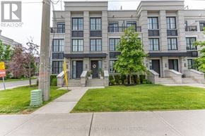 Mississauga (Mineola) townhouse for rent - A building with a lawn in front and a sign that says REALTOR.