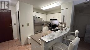 Mississauga (Erin Mills) condo for rent - A kitchen with a marble countertop and stainless steel appliances.