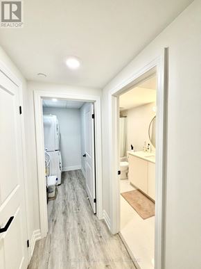 Windsor condo for rent - A hallway with a doorway leading to a bathroom.