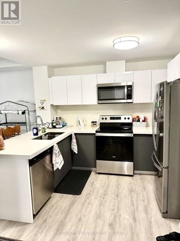 Windsor condo for rent - A modern kitchen with stainless steel appliances and white cabinets.