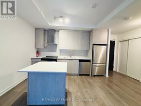 Kitchener condo for rent - A kitchen with a blue island in the middle.