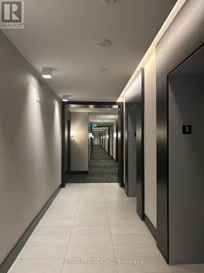 Kitchener condo for rent - A long hallway with elevators on the side.