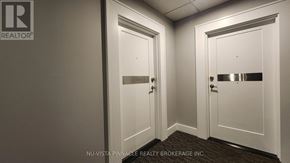 London East (East F) condo for rent - A hallway with two doors and a brokerage logo on the wall.