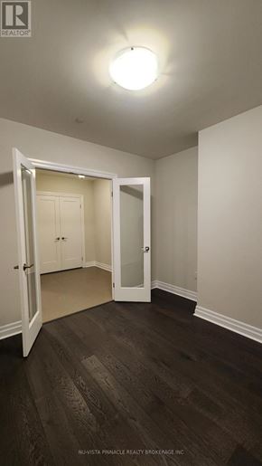 London East (East F) condo for rent - A room with a doorway leading to another room.