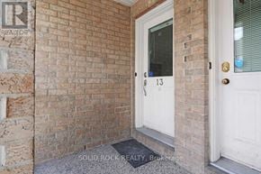 Ottawa townhouse for rent - A white door with a glass window and a number 13 on it.