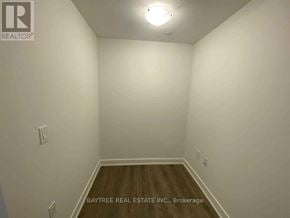 Toronto (Mount Pleasant West) condo for rent - A room with white walls and wooden flooring, with a light fixture on the ceiling.