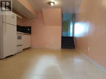 Toronto (L'amoreaux) apartment for rent - A kitchen with a white refrigerator and a stove top oven.