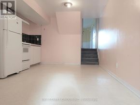 Toronto (L'amoreaux) apartment for rent - A white fridge in a room with pink walls.