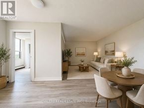 Toronto (Crescent Town) condo for rent - A living room with a couch, chairs, and a dining table.