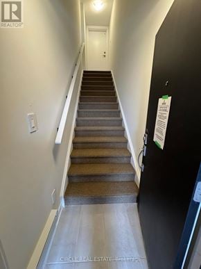 Brampton (Northwest Brampton) townhouse for rent - A staircase with a black wall and a white door.