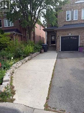 Mississauga (Churchill Meadows) townhouse for rent - A black garage door is on the right side of the house.