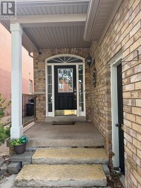 Mississauga (Churchill Meadows) townhouse for rent - A house entrance with a black door and a small plant on the steps.