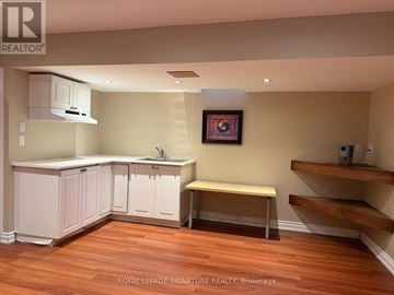 Mississauga (Churchill Meadows) townhouse for rent - A kitchen with white cabinets and a wooden floor.