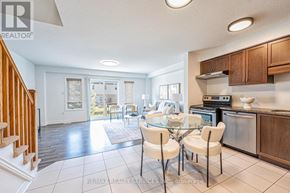 Guelph (Pineridge/Westminster Woods) townhouse for rent - A well-lit kitchen with a dining table set for four.