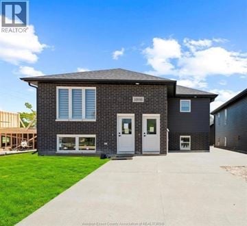 Windsor apartment for rent - A house with a grey roof and a white door is for sale.