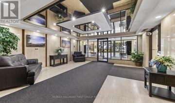 Ajax (South East) condo for rent - A spacious living room with a black couch and a grey rug.