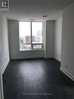 Markham (Unionville) condo for rent - A room with a large window and dark flooring.