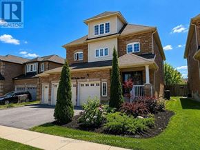 Innisfil (Alcona) apartment for rent - A large house with a driveway and landscaping in front.