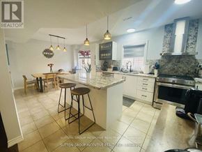 Innisfil (Alcona) apartment for rent - A kitchen with a bar stool and a counter.