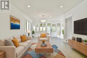 Innisfil apartment for rent - A living room with a white couch, a coffee table, and a painting on the wall.