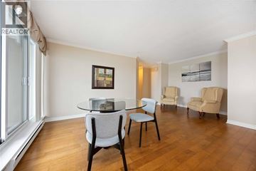Sarnia condo for rent - A living room with a table and chairs.