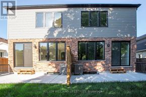 London South (South F) townhouse for rent - A house with a grey facade and a brick chimney is showcased.