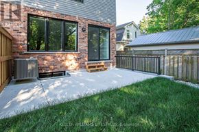 London South (South F) townhouse for rent - A house with a brick wall and a fence in front of it.