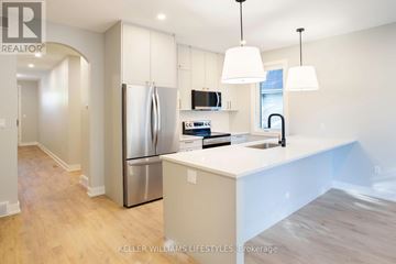 London South (South F) townhouse for rent - A modern kitchen with a stainless steel refrigerator and white countertops.