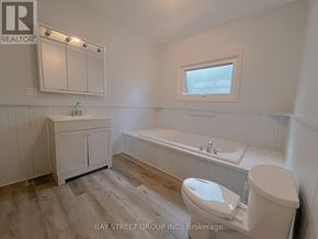 Fort Erie (Central) apartment for rent - A bathroom with a toilet, sink, and bathtub.