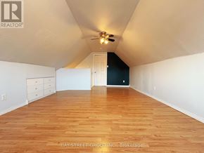 Fort Erie (Central) apartment for rent - A room with wooden flooring and a ceiling fan.
